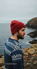 Man in Red Beanie by Rugged Coastal Cliffs