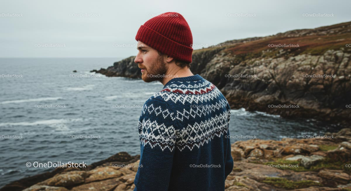 Man in Knitted Sweater by Rugged Coastal Landscape
