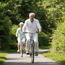 Senior Couple Enjoying a Leisurely Bike Ride in Nature