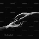 Two Hands Reaching Towards Each Other in Darkness
