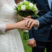 Bride and Groom Holding Hands with Bridal Bouquet
