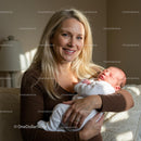 Smiling Mother Holding Her Newborn Baby in Gentle Light