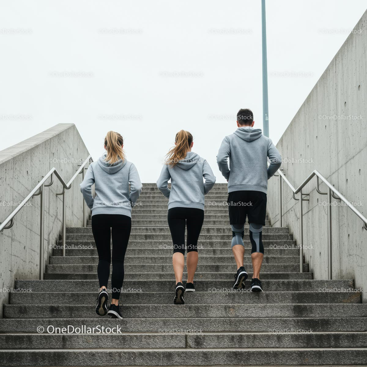 Group Running Up Concrete Stairs in Urban Setting