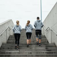 Group Running Up Concrete Stairs in Urban Setting