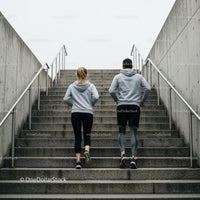 Couple Running Up Concrete Stairs in Urban Environment