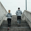 Couple Jogging Up Concrete Stairs in Urban Setting