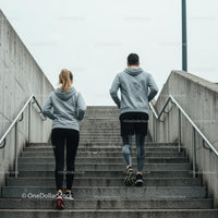 Couple Jogging Up Concrete Stairs in Urban Setting