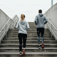Active Couple Jogging Up Concrete Stairs in Urban Setting