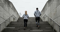 Couple Running Up Concrete Stairs for Fitness Workout