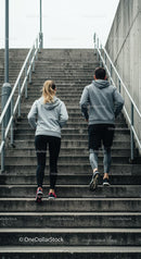Couple Running Upstairs in Urban Environment