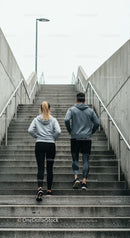 Couple Running on Urban Stairs in Athletic Clothing