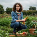 Woman Harvesting Carrots in Lush Garden