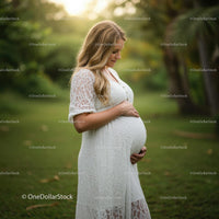 Pregnant Woman in White Dress in Nature