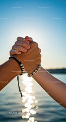 Close-Up of Joined Hands Symbolizing Unity at Sunset