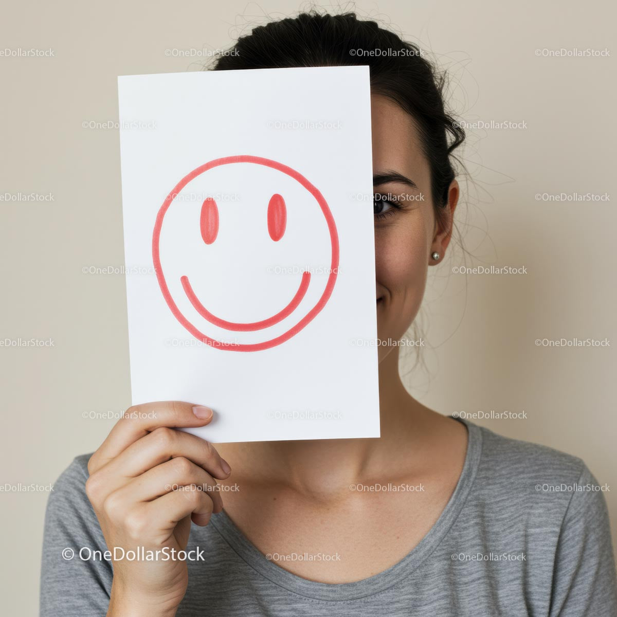 Woman Holding Smiley Face Paper Covering Half of Her Face
