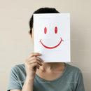 Playful Woman Hiding Face with Smiley Sign