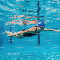 Female Swimmer in Action Underwater at Swimming Pool