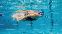 Professional Swimmer Gliding Underwater in Pool