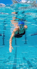Swimmer Gliding Underwater in a Blue Pool