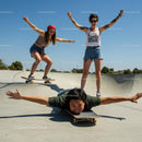 Energetic Teens Skateboarding at Sunny Skatepark