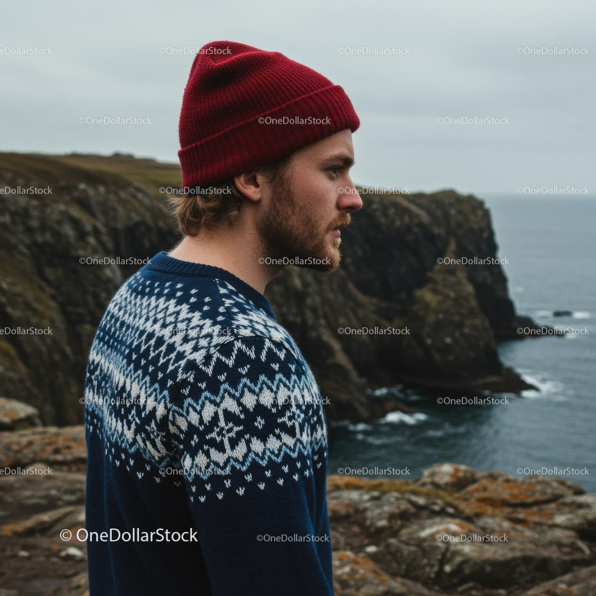 Man in Red Beanie Overlooking Rugged Cliffs