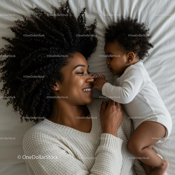 Mother Joyfully Snuggling with Her Baby on a Cozy Bed