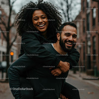 Joyful Couple Enjoying a Playful Piggyback Ride on Urban Street
