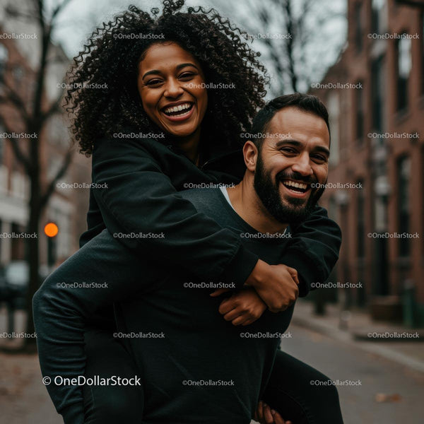 Joyful Couple Enjoying a Playful Piggyback Ride on Urban Street
