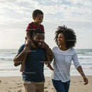 Happy Family Strolling on a Sandy Beach