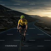 Cyclist on a Scenic Mountain Road at Sunset