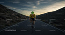 Cyclist in Yellow Jersey Riding at Sunset on Mountain Road