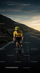 Cyclist Riding Along a Mountain Road at Sunset