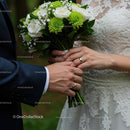 Hands of Newlyweds Holding Wedding Bouquet