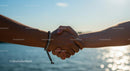 Handshake by the Sea on a Sunny Day