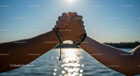 Hands in Unity Against a Sunlit Sky