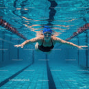 Female Swimmer Gliding Underwater in Swimming Pool