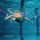 Female Swimmer Perfecting Freestyle Stroke Underwater
