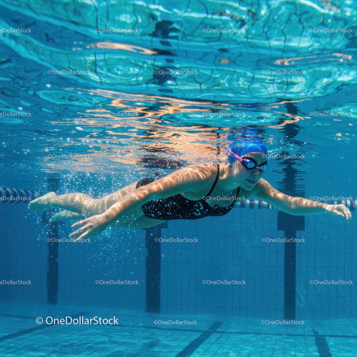 Professional Female Swimmer in Blue Water Pool
