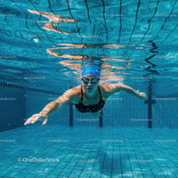 Female Swimmer Freestyle in Clear Pool Water