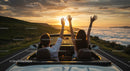 Couple Enjoying Scenic Sunset Drive in Convertible