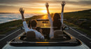 Couple Enjoying Scenic Drive at Sunset in Convertible