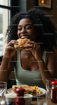 Joyful Woman Savoring a Delicious Burger Indoors