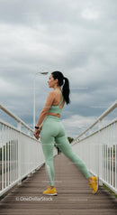 Woman Stretching on Bridge in Mint Green Activewear