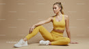 Woman in Yellow Activewear Stretching on Beige Background