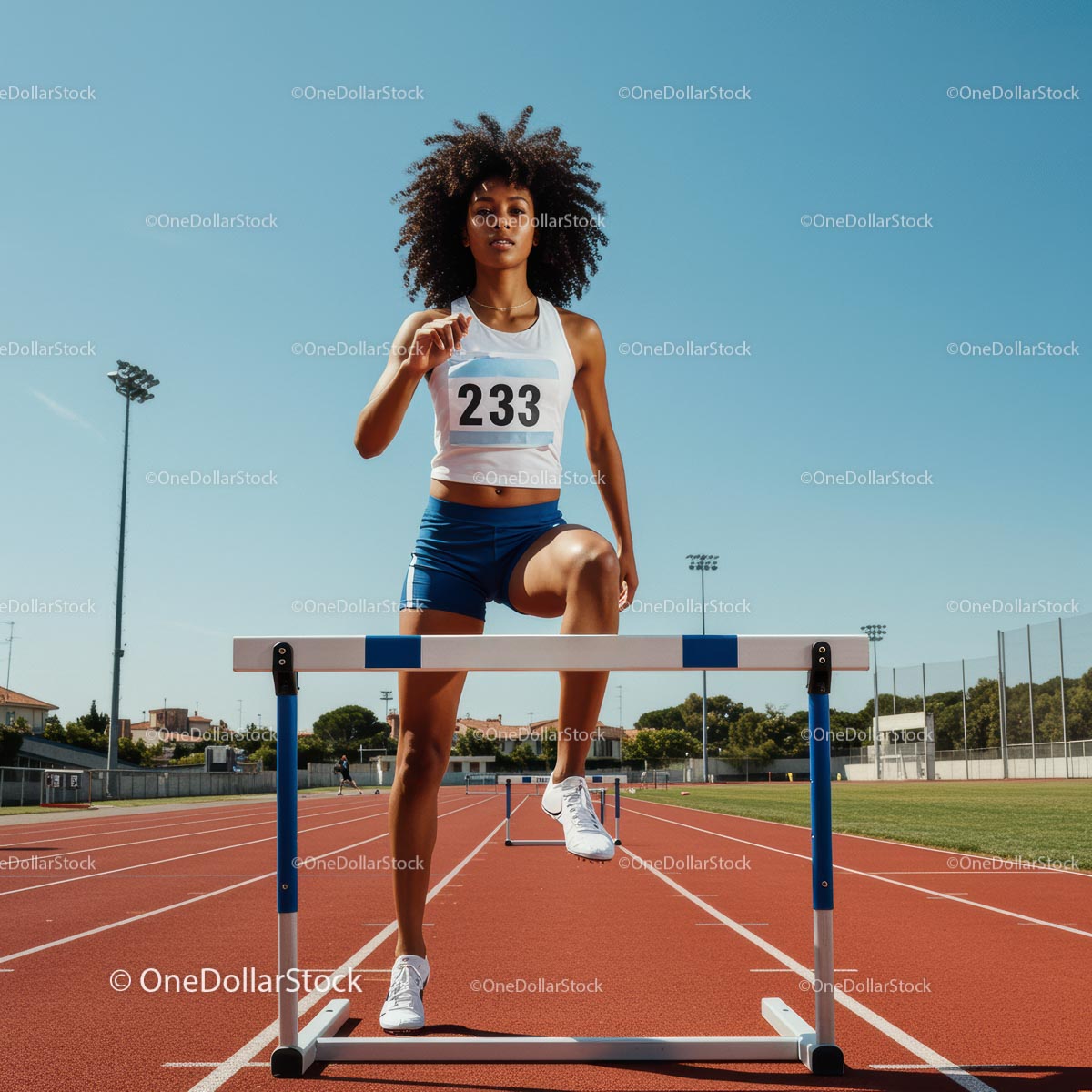 Female Athlete Hurdling on Sunny Track
