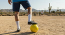 Soccer Game in a Desert Field with Yellow Ball