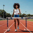 Athletic Woman Training on Outdoor Track with Hurdles
