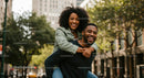 Smiling Couple in an Urban Setting Enjoys Piggyback Ride