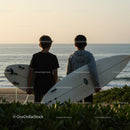 Two Surfers with Boards Watching Ocean Sunset