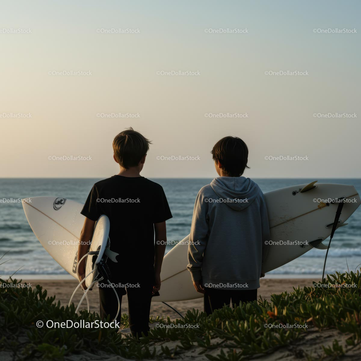 Young Surfers Watching the Ocean at Sunset